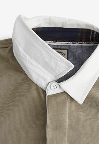 Next Pólóing - neutral brown