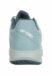 Light blue athletic shoe with a textured mesh upper and white Yonex logo. Features a flexible sole with rubber traction pattern for grip.