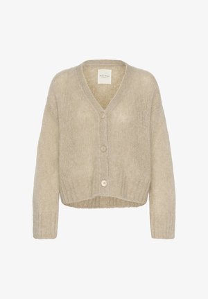 Bēša adīta kardigans ar V veida izgriezumu, garām piedurknēm un īsu maliņu. Raksturīga ar pogu aizdari un mīkstu, teksturētu audumu.