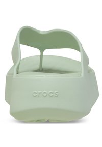 Sandali platform in gomma verde con schienale aperto, fascia larga e suola texturizzata. Presentano il logo "crocs" in rilievo sul tallone.