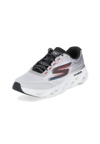 White and gray athletic shoe with a textured mesh upper, black laces, and a thick, cushioned sole featuring round cutouts. Notable red and blue accents.