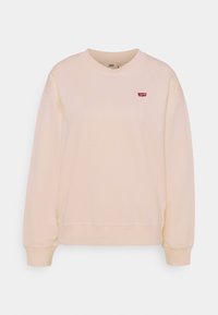Felpa beige chiaro realizzata in tessuto morbido. Caratterizzata da un collo tondo, maniche lunghe e un piccolo logo rosso di Levi's sul petto.