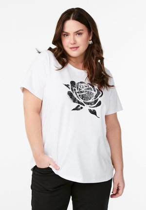T-shirt blanc à manches courtes avec un graphique de rose noire sur le devant. Matière en coton doux avec une coupe décontractée. Pantalon noir pour compléter le look.