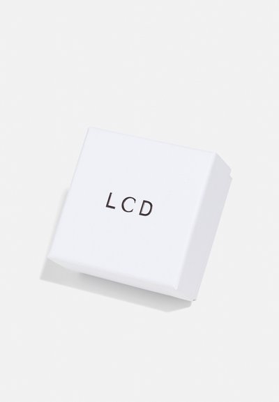 Witte vierkante doos met een matte afwerking, met zwart "LCD"-schrift op de bovenkant, licht gekanteld voor een diepte-effect.