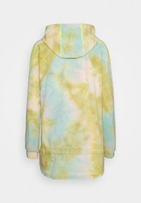 Huvtröja i tie-dye-mönster med pastellgul, blå och grön färg och synlig sömnad. Mjuk, texturerad tyg.