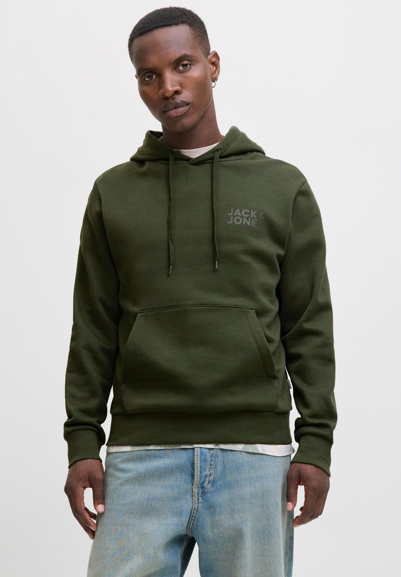Olive green hoodie with front pocket, drawstring hood, and small logo on chest. Soft material, relaxed fit, paired with light blue jeans.