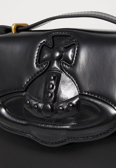 Black leather handbag featuring a textured embossed design with rounded shapes and raised accents, stitched detailing, and a top handle.