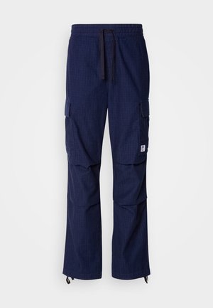 Navy blue cargo pants made from textured fabric; features include an elastic waistband, drawstring, and multiple side pockets.