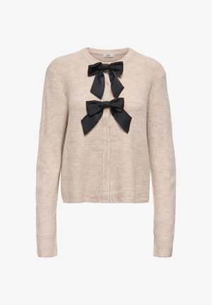 Gestrickte beige Strickjacke mit rundem Ausschnitt, zwei schwarzen Satinschleifen vorne. Lange Ärmel und gerippte Struktur.