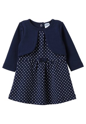 Mørkeblå kjole med lange ermer og prikkete mønster; har en matchende bolero-stil topp og en knytting i midjen.
