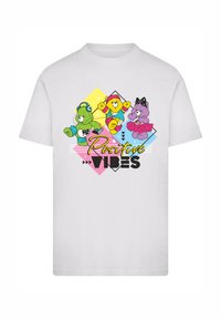 White t-shirt featuring colorful cartoon bears and the text "Positive Vibes," set against geometric shapes in yellow, blue, and pink.