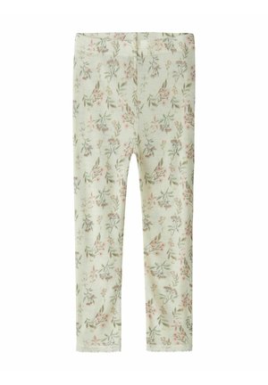 Leggings doux couleur crème avec un imprimé floral délicat sur l’ensemble en nuances rose et vert atténuées, avec une bordure en dentelle aux chevilles.
