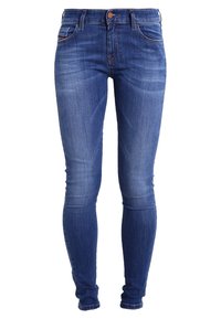 Modré džíny skinny s středním pasem, pěti kapsami a jemným vyblednutím. Obsahují kovový knoflík a olemování.