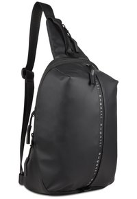 Black sling backpack with a sleek, smooth texture, featuring a zippered main compartment, adjustable strap, and subtle logo detail on the side.