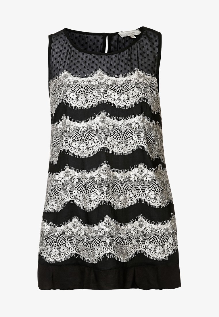 Robe noire sans manches avec un panneau supérieur en tulle à pois transparents et quatre bandes horizontales en dentelle blanche à motifs floraux sur le devant.