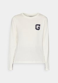 Langarm-Creme-T-Shirt aus Baumwolle mit einem navyblauen Logo-Graphic in einem Kästchen auf der linken Brust. Rundhalsausschnitt und lässige Passform.