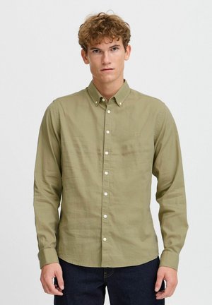 Long-sleeve olive green button-up shirt made of lightweight fabric, featuring a small logo, white buttons, and a straight hem.