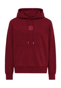 Felpa con cappuccio color bordeaux realizzata in tessuto morbido. Presenta una tasca frontale, un cordino e una toppa con logo quadrato sul petto.