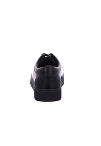 Black leather sneaker with a smooth finish, rounded heel, and textured rubber sole. Features a clean design and minimal stitching.