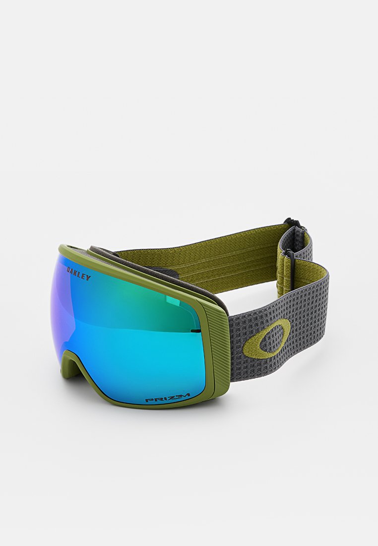 Zielono-szare gogle narciarskie z dużym, lustrzanym niebieskim szkłem. Posiadają regulowany pasek oraz teksturowane akcenty dla lepszego chwytu.