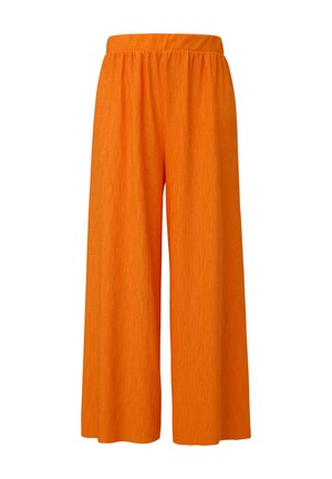 Pantalons orange à jambe large avec une taille élastique, présentant un tissu texturé qui crée des lignes verticales sur la surface.