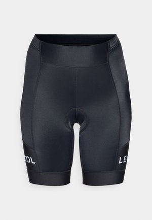 Calças de ciclismo pretas com um corte justo, feitas de um tecido liso e elástico. Apresenta área de assento almofadada e um logótipo branco em contraste no lado.