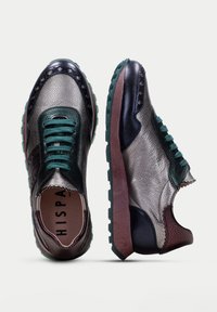 Sneakers with mixed metallic leather in silver, green, and dark blue, featuring a textured finish, green laces, and a chunky sole.