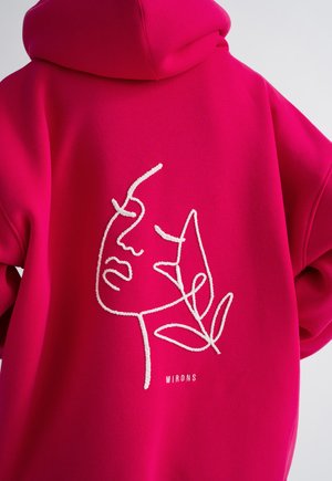 Felpa fucsia con un'illustrazione di un volto disegnata con una linea bianca e il testo "MIRONS" sottostante. Tessuto morbido e design dalla vestibilità rilassata.