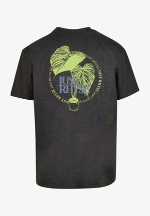 Must musta, millel on roheline graafika kahe lehe ja taimepoti kujutisega, seljal sinine tekst "JUST RHYSE" ja ümbritsevad tekstid rohelises värvitoonis.