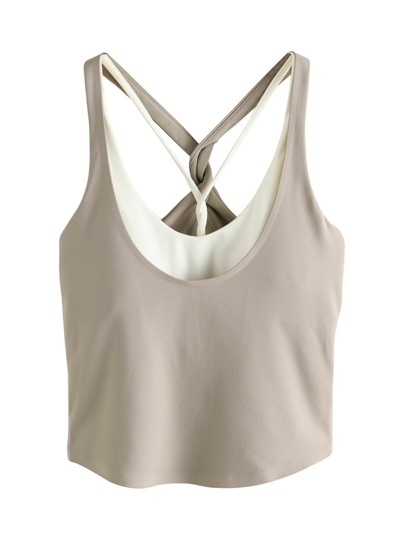 Beež värvi lühike põlvpikkusega topp ümarate kaeluse ja kriss-krossi seljaga, millel on kontrastne valge vooder. Sile kangapind.