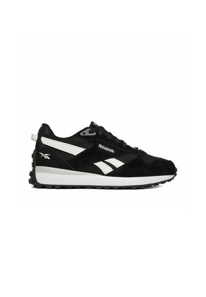 Black and white Reebok sneaker with lace-up design, white midsole, textured black outsole, and brand logos on side and heel.