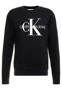 Czarny sweter z bawełny, posiada okrągły dekolt, długie rękawy, ściągacze na nadgarstkach oraz białe logo Calvin Klein Jeans z przodu.