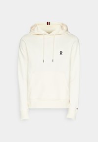 Felpa crema realizzata in cotone, con tasca frontale e cordini. Presenta un piccolo logo ricamato e polsini a costine.