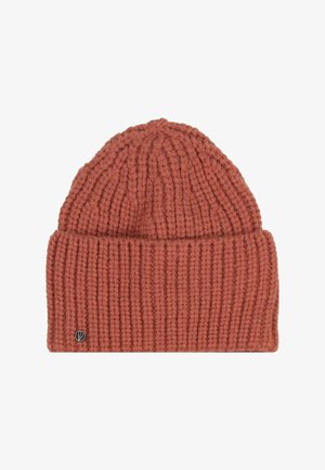 Rust-colored knitted beanie with a folded cuff and a small round metal logo on the cuff.