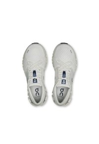 White athletic shoes with a mesh upper, lace-up closure, and cushioned sole. Features blue logo and "CLOUD X" label on the tongue.