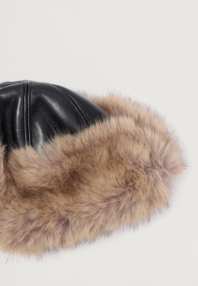 Zwarte leren hoed met een tan faux fur rand, voorzien van een gestructureerde oppervlakte en gewatteerde ontwerpelementen, geschikt voor koudere weersomstandigheden.