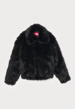 Cazadora recortada de pelo sintético negro con un amplio cuello, textura suave y una etiqueta de marca visible en rojo dentro del escote.