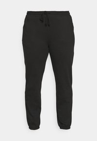 Schwarze Jogginghosen aus weichem Stoff, mit einem elastischen Taillenbund und einem Zugband sowie elastischen Bündchen an den Knöcheln.