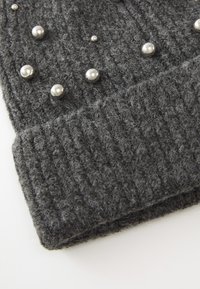Gray knit beanie with a ribbed texture, featuring silver metallic studs scattered across the surface for added detail.
