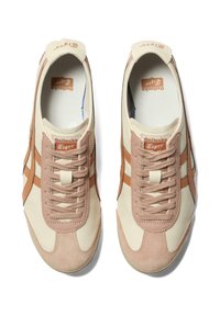 Onitsuka Tiger sneakers with a creamy upper, beige suede accents, and brown stripes. Featuring classic lacing and logo detail on the tongue.