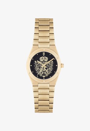 Goldene Metalluhr mit schwarzem Zifferblatt, das ein Kronen- und Totenkopfdesign zeigt, verziert mit einem Gliederarmband und goldenen Akzenten.