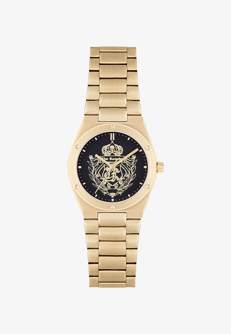 Goldene Metalluhr mit schwarzem Zifferblatt, das ein Kronen- und Totenkopfdesign zeigt, verziert mit einem Gliederarmband und goldenen Akzenten.