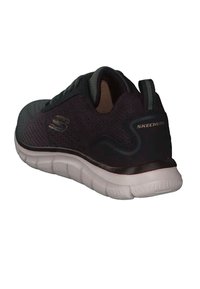 Schwarzer Mesh-Laufschuh mit einer gepolsterten weißen Sohle, abgerundeter Form, S-Logo an der Seite und strukturierten Akzenten an der Ferse und dem Obermaterial.