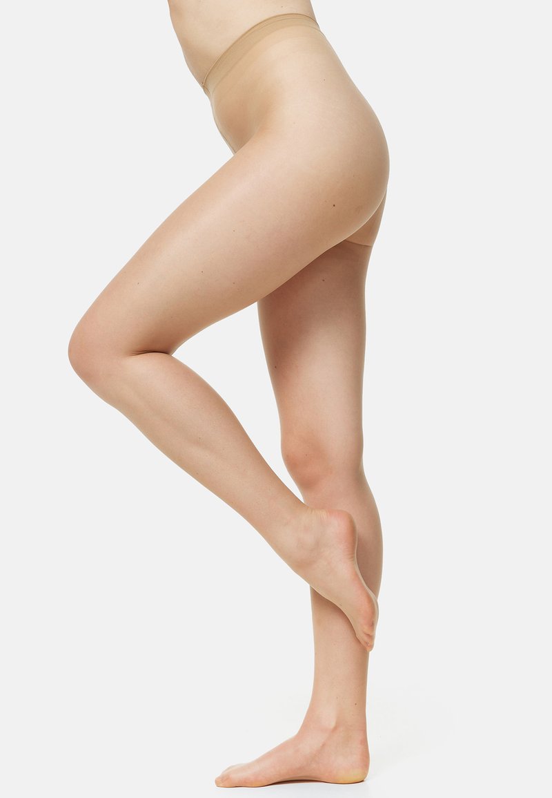 Pantimedias desnudas de tejido transparente con textura suave, cintura alta y un diseño discreto que contornea las piernas. Acabado transparente.