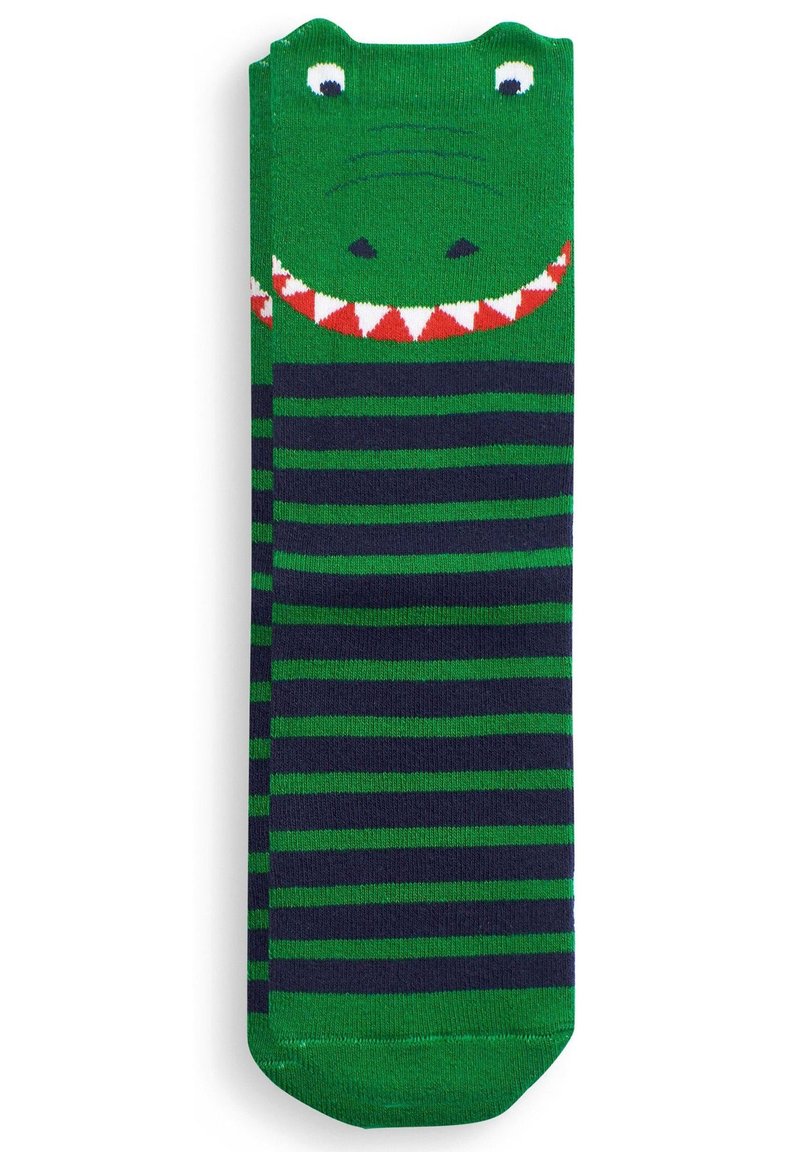 Grønne strømper med marinblå striber har et krokodille-design øverst, med øjne, et bredt grin og detaljer i røde og hvide trekanter som tænder.