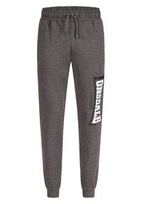 Pantalones de chándal grises confeccionados en un tejido suave, con una cinturilla elástica con cordones y una gran impresión de logo en blanco en el lateral.