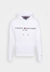 Biała bluza z kapturem wykonana z mieszanki bawełny, z przednią kieszenią, kapturem ze sznurkiem oraz navy niebieskim logo "TOMMY HILFIGER EST. 1985".