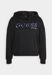 Sweat à capuche noir avec logo "GUESS" en sequins et texte "EST. 1981", capuche à cordon, manches longues et poignets et ourlet côtelés.