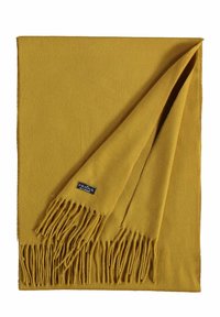 Scarf di colore giallo senape realizzato in un tessuto morbido, con frange sottili lungo un bordo e una piccola etichetta nell'angolo. Forma piatta e rettangolare.