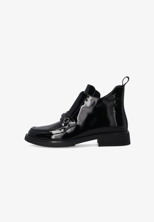 Black patent ankle boots with a sleek design, flat sole, elastic side panels, and a decorative metal buckle on the front.